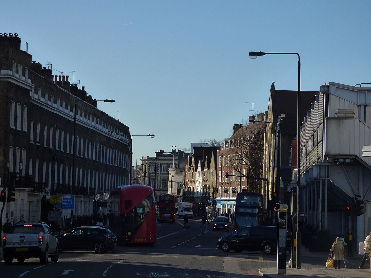 Camden Road in London, with its terrace of buildings and buses.