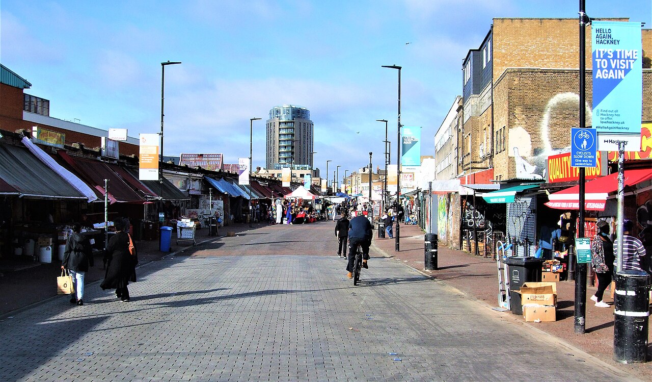 Market stalls and shoppers on Ridley Road in Dalston, London.