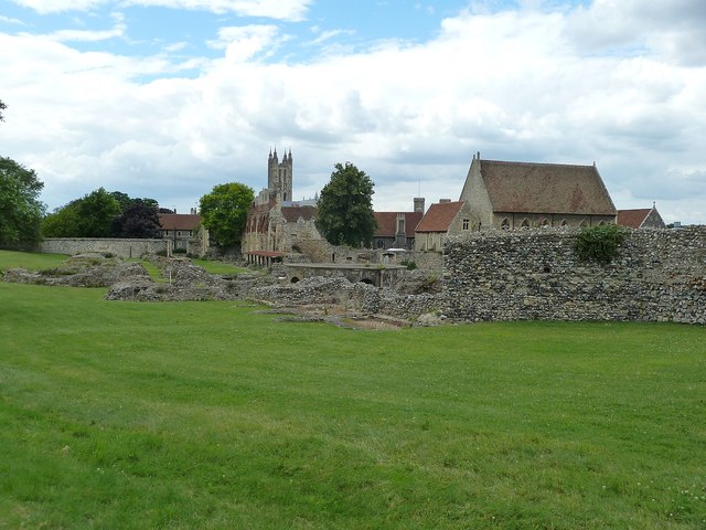 Stone foundations and ruined walls at St Augustine’s Abbey in Canterbury, with the cathedral in the distance.