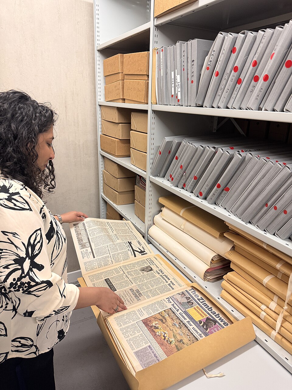 An archivist with materials in the Black Cultural Archives repository.