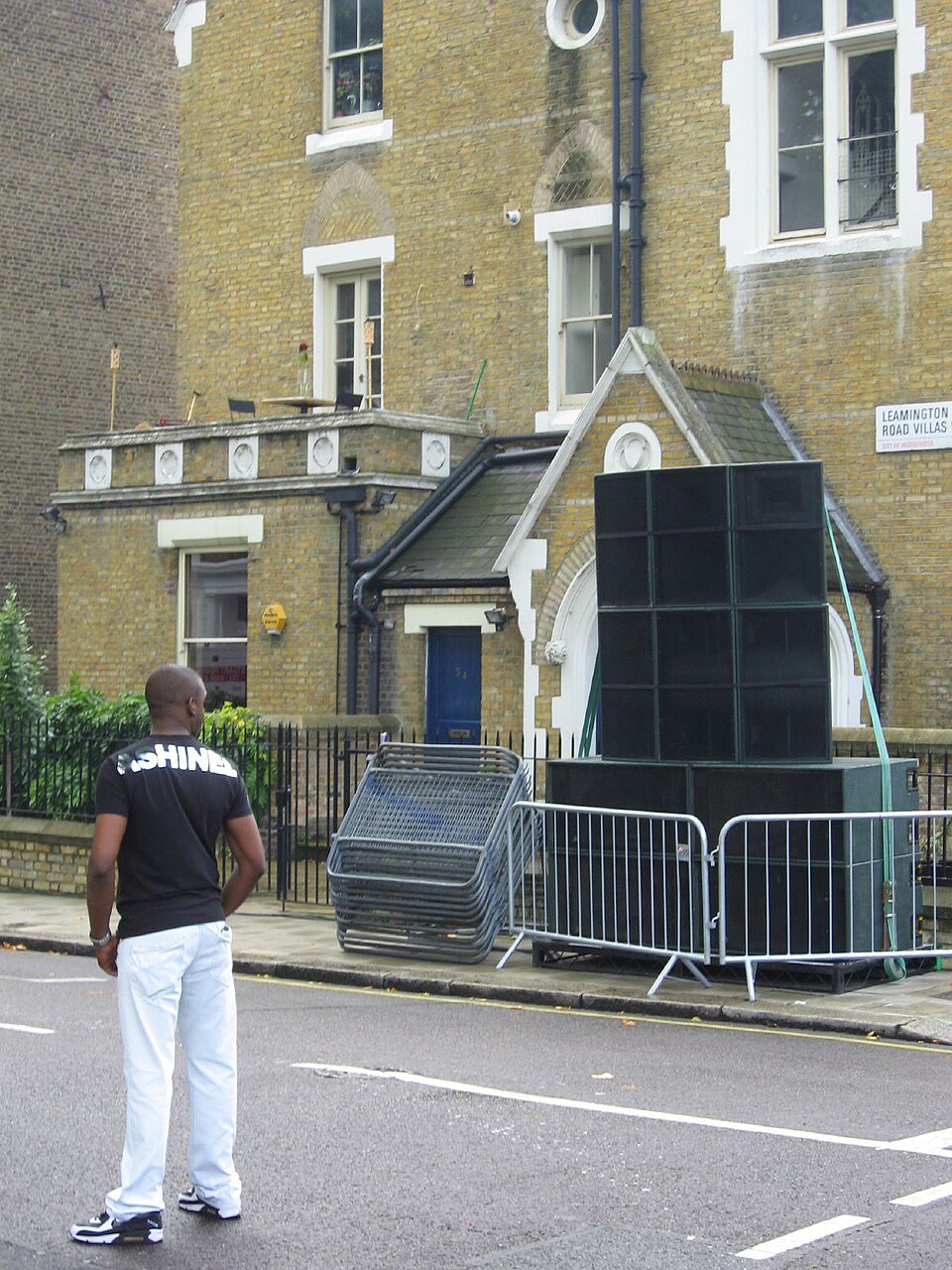 A tall stack of loudspeakers outside a brick building at Notting Hill Carnival in 2008.