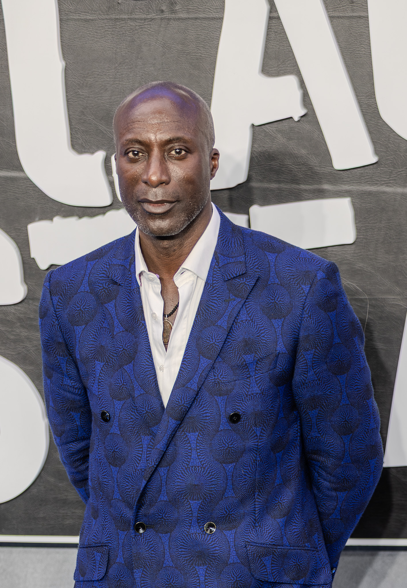 Ozwald Boateng wearing a patterned blue suit at a London film premiere.