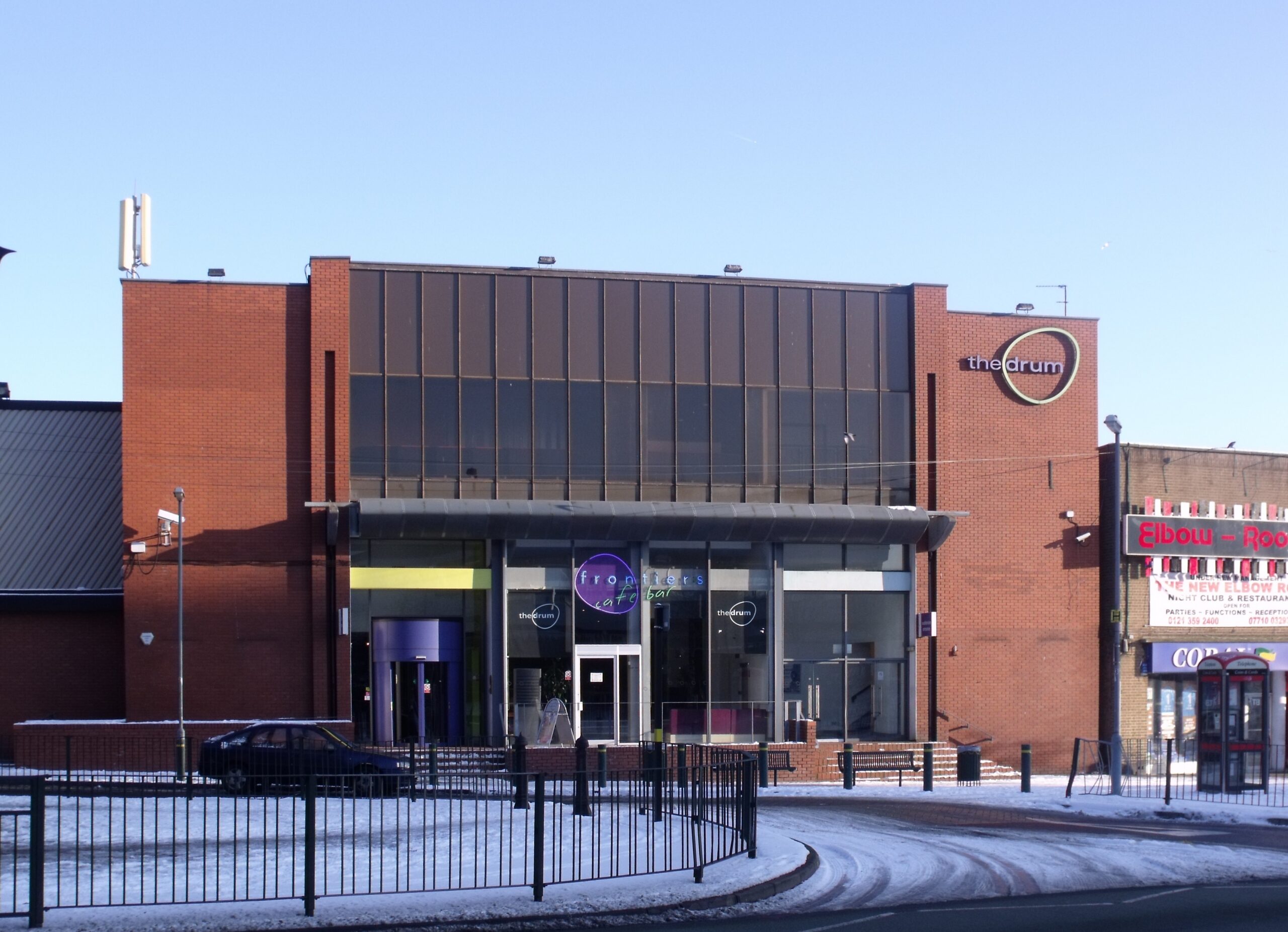 Brick and glass frontage of the Drum arts centre in Birmingham, with its name above the entrance.